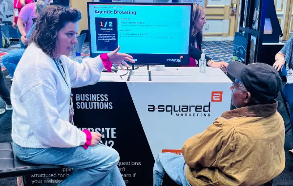 Anna Anderson speaking with a man at a trade show.