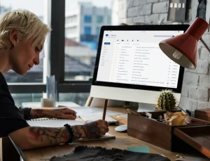 Woman building an email list on computer.