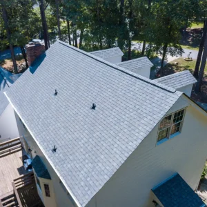 A new roof on a home with 3 gable windows and a chimney.