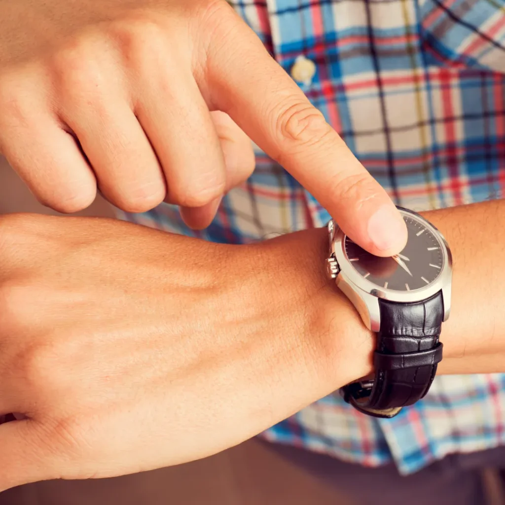 Man with a watch that he is pointing at.